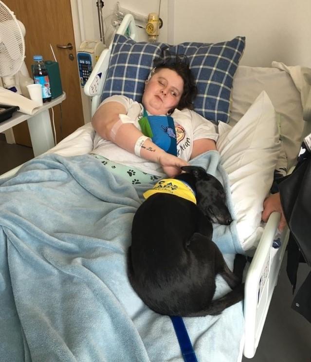 A child sleeping in a dog bed Description automatically generated