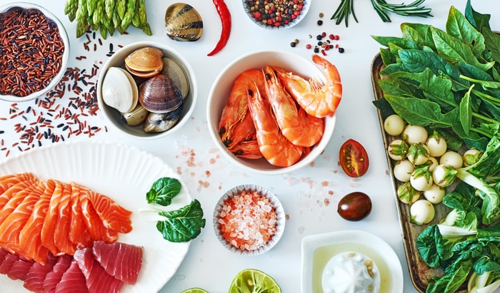Top view of clean eating ingredients over white background